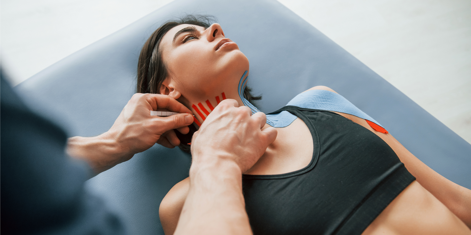 Putting kinesio tape on the neck. Woman visiting physiologist.