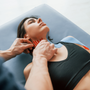 Putting kinesio tape on the neck. Woman visiting physiologist.