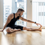 Young handsome man practicing yoga at home