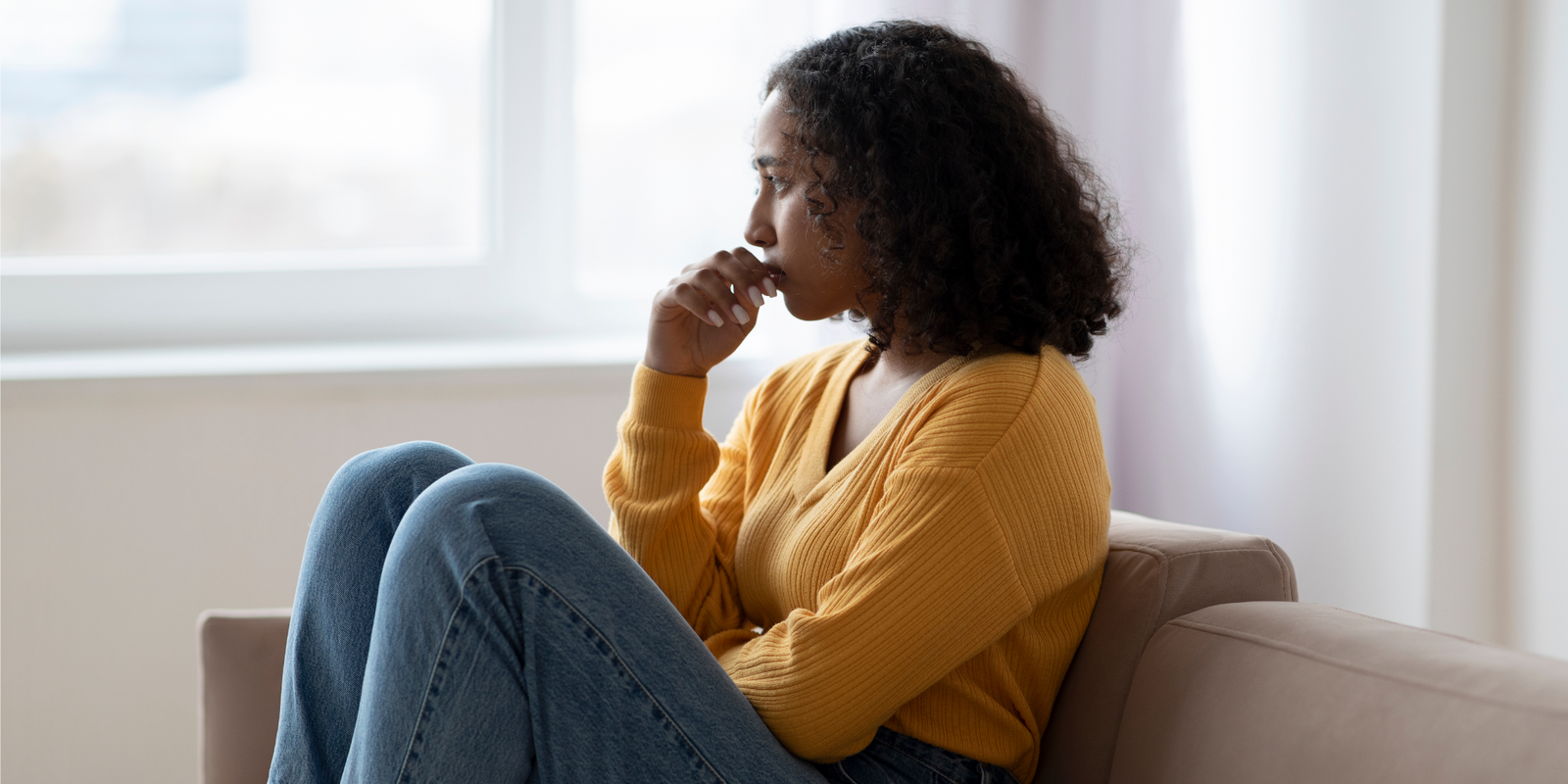 Mental health care. Depressed young black woman suffering from emotional burnout on couch at home