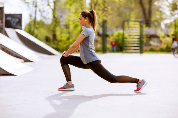 young woman stretching in the park
