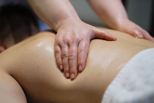 Close-up of man enjoying in relaxing back massage . Man relaxing on massage table receiving massage.