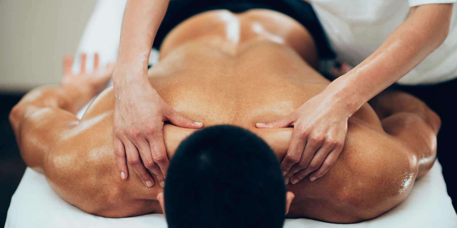 Sports massage. Therapist working with shoulders
