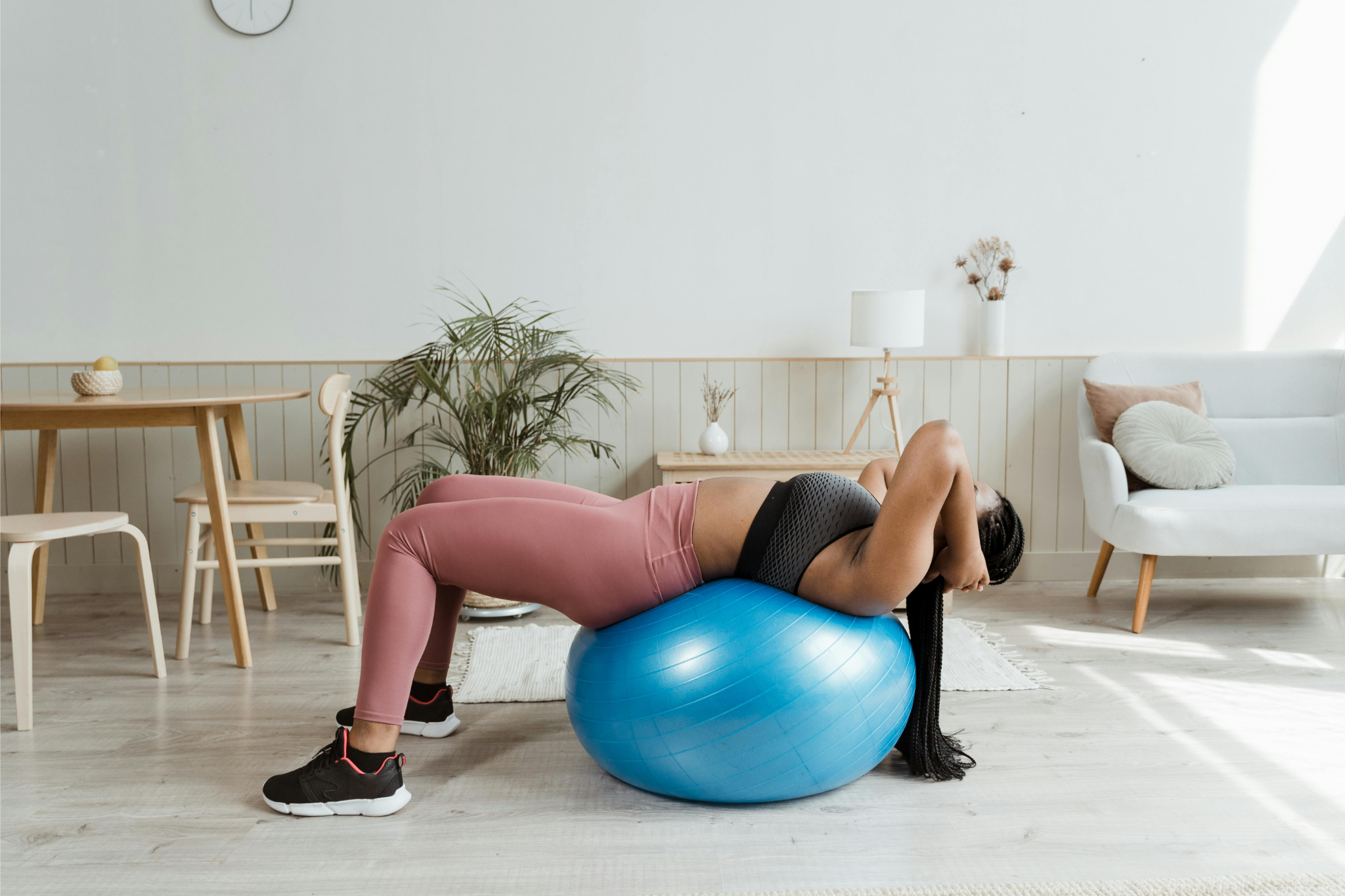 woman in exercise ball exercising, stretching, back pain movements