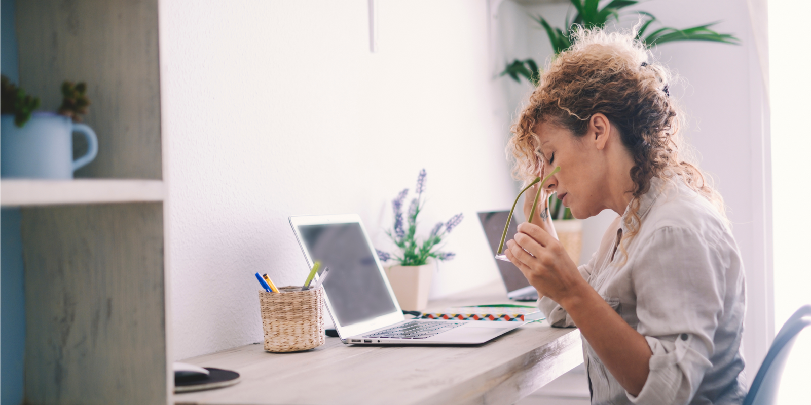 Tired stressed middle age business woman suffering from neckpain working from home office sitting at table. Overworked adult lady massaging neck feeling hurt pain from incorrect posture. Lifestyle