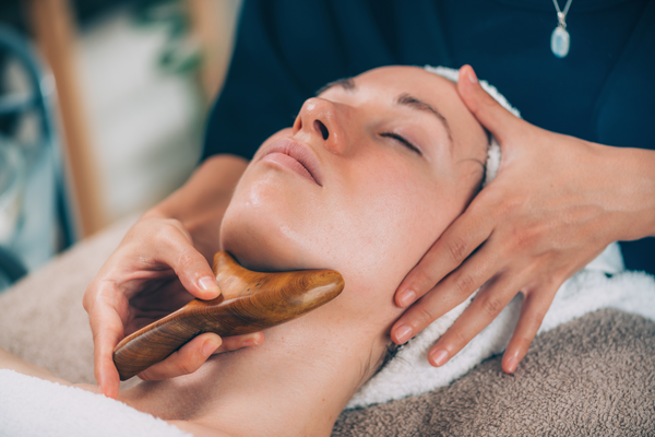Lymphatic drainage face massage with wooden massager