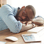 Taking a break. Tired afro american man in glasses sleeping at his working place at home. Afro american businessman feeling exhausted and sleeping at work. Freelance. Home office workplace