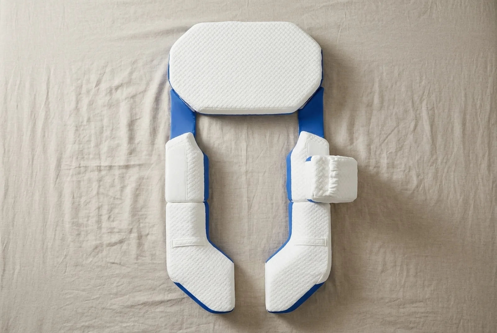 The complete Modular Pillow system laid out on a bed, seen from above