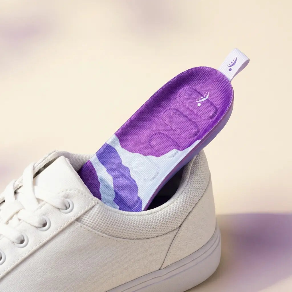 Image 1:1, the insole sliding into an everyday sneaker, clean and well-lit. No text.